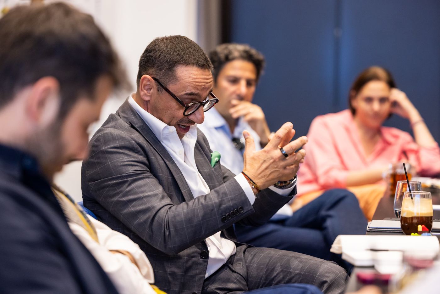 A participant making a point across the table